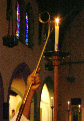 acolyte lighting a candle